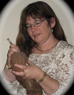 A woman holding a coconut and wearing glasses.