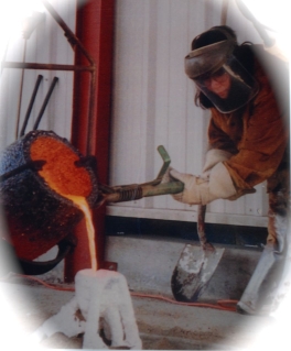 A man in brown jacket and mask working with metal.